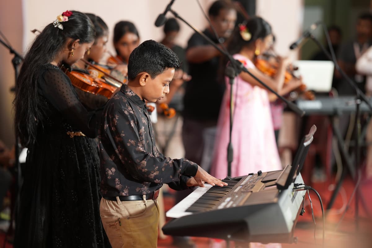 Children performing music on stage